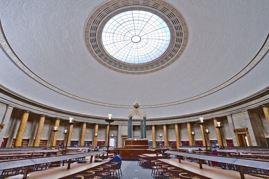 Panoramic view of Manchester Central Library's stunning reading room with grand dome and vintage architecture.